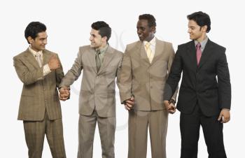 Four businessmen standing with holding hands