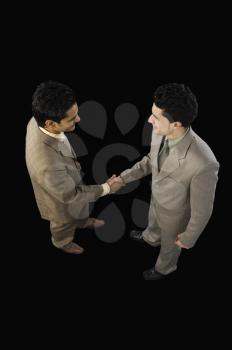 High angle view of two businessmen shaking hands