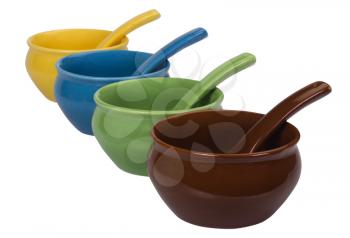Close-up of ceramic bowls and soup spoons