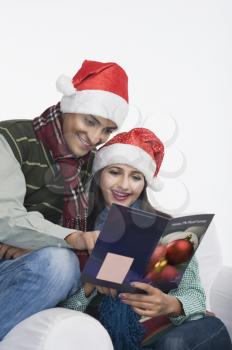 Couple reading a greeting card and smiling