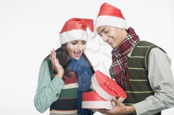 Couple looking at a Christmas present