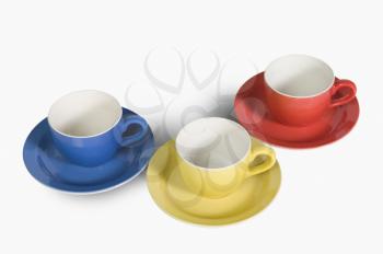 High angle view of colorful tea cups with saucers