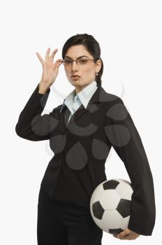 Businesswoman holding a soccer ball