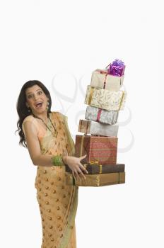 Surprised woman holding gifts at Diwali festival