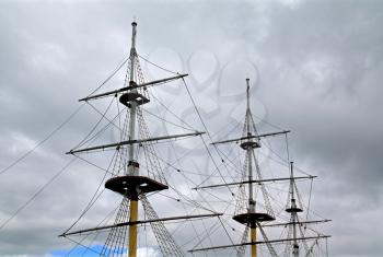 ship masts on cloudy sky