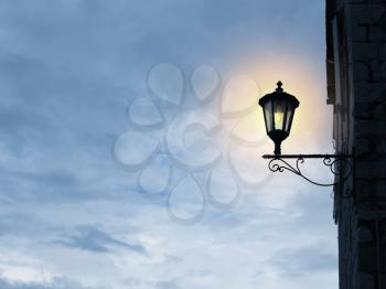 Old fashioned street light on sky background