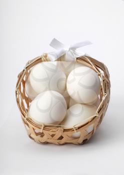 egg in basket on light background