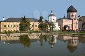 monastery is reflected in lake with water