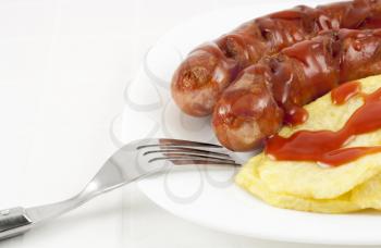 Fried sausages and potatoes with ketchup