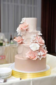 Big wedding four tiers cake with flowers.