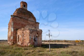 Old destroyed and abandoned church against the blue sky