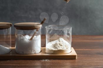 Condiments in the glass bottle on wooden table, still life photography