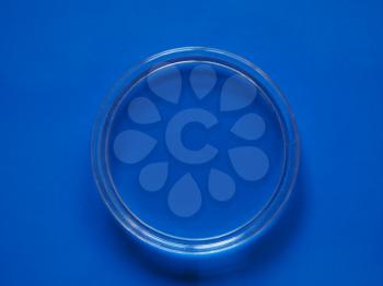 A Petri dish (aka Petrie dish, Petri plate or cell culture dish) cylindrical glass or plastic lidded dish used to culture cells such as bacteria or mosses over blue background