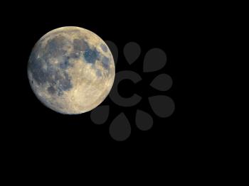 Full moon seen with an astronomical telescope, with enhanced colours to show the real colours of terrain surface - with copy space