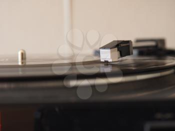Vinyl record spinning on a turntable, focus on needle