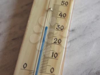 thermometer thermostat instrument to measure air temperature showing hot weather (30 C) or cold weather (30 F)