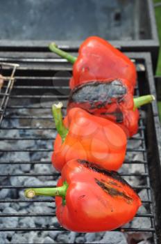 Royalty Free Photo of Red Peppers on a Barbecue