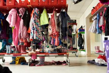 children coat rack with colorful clothes at school