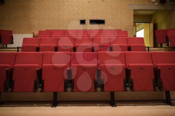 Theater room with red chairs in a school building