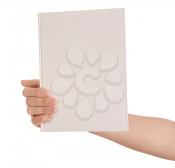 Female hand holding book with blank cover on white background�