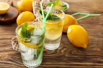 Glasses of fresh lemonade on wooden table�
