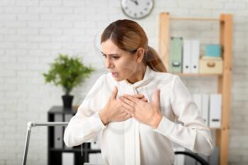 Woman having panic attack at workplace�