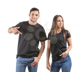 Young man and woman in stylish t-shirts on white background�