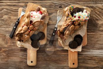 Delicious sweet bubble waffles on wooden table�