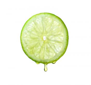 Essential oil dripping from lime slice on white background�
