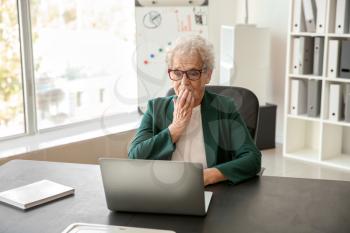 Elderly woman after making mistake during work with laptop�