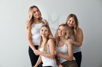Beautiful young women on light background. Concept of body positivity�