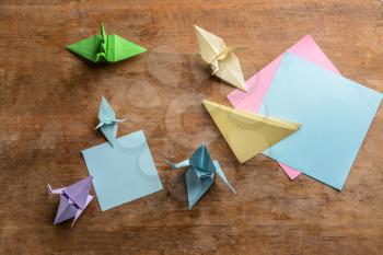 Origami cranes on wooden table�