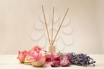 Reed diffuser and dry flowers on table�