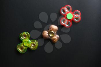 Stroboscopic photo of moving spinners on dark background�