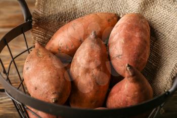 Raw sweet potato in basket, closeup�