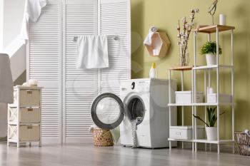 Interior of home laundry room with modern washing machine�
