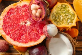 Assortment of tasty exotic fruits on table, closeup�