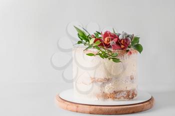Sweet cake with floral decor on light background�