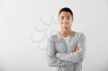 Portrait of African-American teenage boy on grey background�