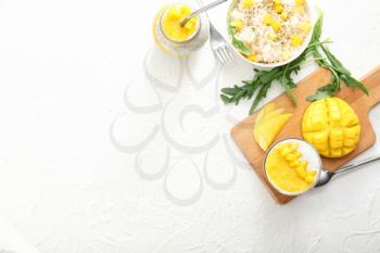 Tasty rice and dessert with mango on white table�