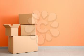 Cardboard boxes near color wall�
