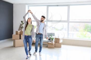 Young couple dancing in their new house�