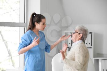 Medical worker mistreating senior woman in nursing home�