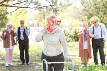 Happy disabled senior woman celebrating Birthday in park�