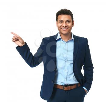 Handsome businessman pointing at something on white background�
