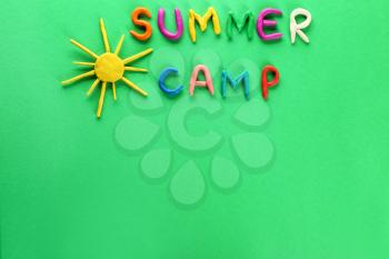Text SUMMER CAMP and sun made of plasticine on color background�