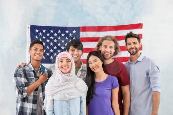 Group of students near wall with USA flag�