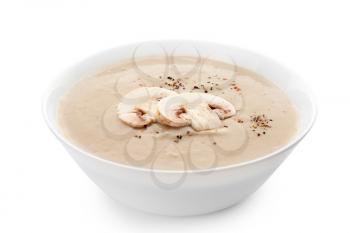 Bowl of tasty mushroom cream soup on white background�