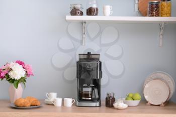 Modern coffee machine in kitchen�