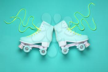 Vintage roller skates on color background�